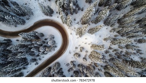 AERIAL: Top Aerial View Of Snow Mountain Landscape With Trees And Road. Dolomites, Italy. 