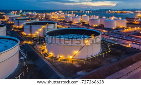 Aerial top view storage tank farm at night, Tank farm storage chemical petroleum petrochemical refinery product at oil terminal, Business commercial trade fuel and energy transport by tanker vessel.