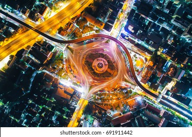 aerial top view traffic circle with speed light in city at night , Victory Monument , bangkok , thailand .