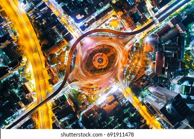 Aerial Top View Traffic Circle With Speed Light In City At Night , Victory Monument , Bangkok , Thailand .