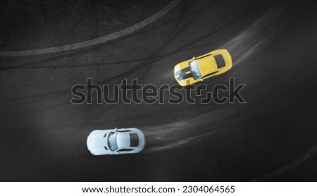 Aerial top view two cars drifting battle on race track, Two race cars view from above.