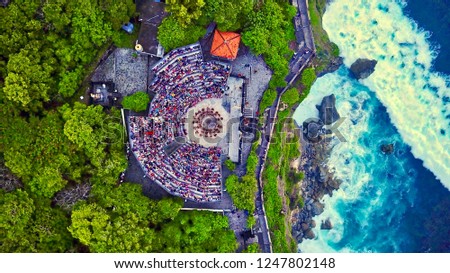 Aerial top view of Uluwatu temple’s arena during the sunset ceremony Kecak dance in Bali, Indonesia