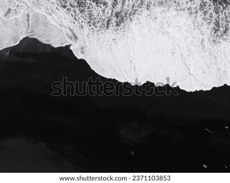 Aerial top view of wave of Black Sand Beach Reynisfjara in Iceland.