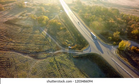 Aerial Top View Of White Truck With Cargo Semi Trailer Moving On Road In Direction.