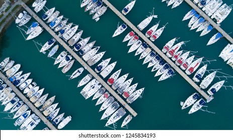Aerial top view of a lot of white yachts and sailboats moored in marina on a turquoise water, summer season. Yacht week, hundreds of boats in port. Monaco, France, Croatia, Italy, Fort Lauderdale.