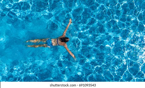 Aerial Top View Of Woman In Swimming Pool Water From Above, Tropical Vacation Holaday Concept
