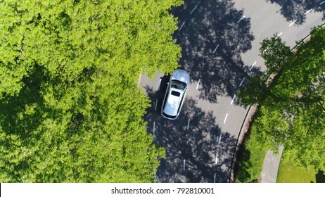 Aerial Top-down Photo Silver Grey Self Driving Test Car Driving Through Corner Simple Two Lane Road With Trees Left And Right At Side Of Road