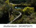 An aerial, top-down view of the boardwalk through the UHCL wetlands leading to Horsepen Bayou in Clear Lake, Houston, Texas.