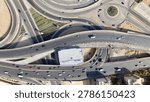 Aerial top-down view of the complex Ring Road highway interchange and overpass system, featuring a roundabout and moving traffic in Egypt.