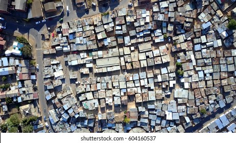 Aerial Top-down View High Altitude Of Slum A Heavily Populated Urban Informal Settlement Characterized By Substandard Housing And Squalor Poor Living Conditions Streets And Rusty Metal Home Roof Tops