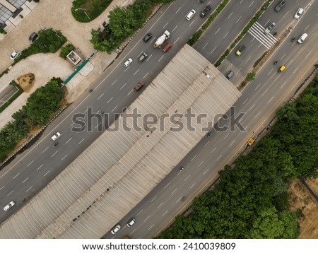 Aerial top-down view of multi-lane road with underpass and light traffic at Gurugram India at daytime - diagonal drone shot