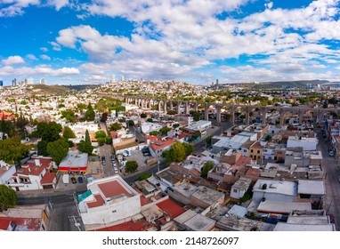 Aerial Tour Over The Famous Aqueduct Of Querétaro In The Center Of The City Surrounded By Constructions With A Beautiful Sunrise In The Background