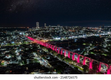 Aerial Tour Over The Famous Aqueduct Of Querétaro In The Center Of The City Surrounded By Constructions Illuminated By Lamps On A Quiet Night