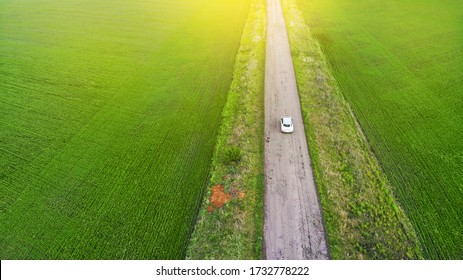 Aerial. Tourism By Car Concept. One Car Driving By The Rustic Road. 