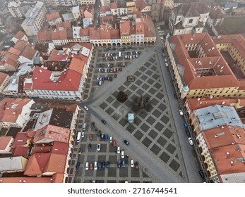Aerial Triangular Square Framed By Rooftops Warm Afternoon Light, Parking Lines, Potential Market Activation,