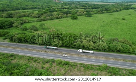 Similar – Foto Bild Zwei Tanklastzüge überqueren eine Autobahn über eine Brücke, Luftaufnahme.