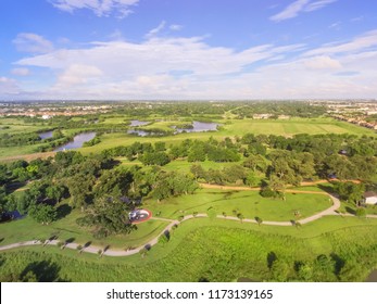 Aerial Urban Green Park With Suburban Houston Neighborhood In Distance. S-curved Pathway, Tree, Grassy Lawn, Trail For Jogging, Running, Exercising Outdoor, Large Tai Chi Circle Of Ying Yang In Middle