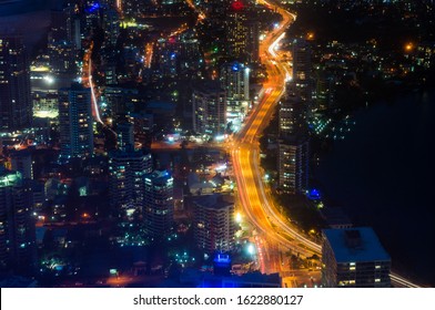 Aerial Urban Night Traffic With Busy Highway. Modern City Infrastructure, Commercial District. Gold Coast, Australia 