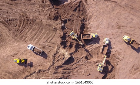 Aerial: Vast Excavation Site With Multiple Heavy Industry Vehicles.