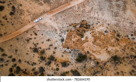 Aerial veiw of four wheel drive vehicle and large caravan on an outback road in Australia.
