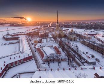 Aerial video winter panorama Peter and Paul Fortress, frozen Neva river at sunset, Smoke from pipes, Petrovskaya embankment, Winter Palace, Palace bridge