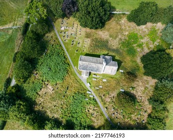 Aerial View Of 12th Century Chapel. St Mary's Church Stainburn Built English Gothic Architecture And Set Within British Countryside