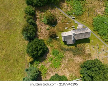 Aerial View Of 12th Century Chapel. St Mary's Church Stainburn Built English Gothic Architecture And Set Within British Countryside