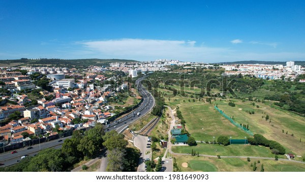 Aerial view from the A5 highway and at right side\
a golf camp. Oeiras