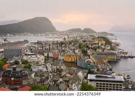 Aerial view of Aalesund from the viewpoint Aksla in the foggy day in the summer .Art nouveau architectural buildings reflected in the water in the Norwegian town Aalesund