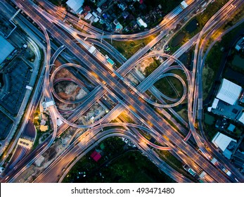 Aerial View Above of Busy Highway Road Junctions at Night. The Intersecting Freeway Road Overpass The Eastern Outer Ring Road of Bangkok.
