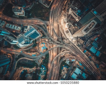 Aerial View Above of Busy Highway Intersection Road Junctions at morning. The image contain soft focus, grain and noise.