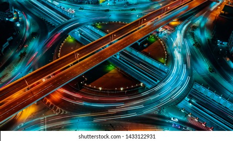 Aerial View Above Of Elevated Road Junction And Traffic An Important Transport At Night. Transportation And Travel Concept.