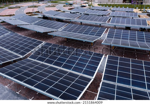 Aerial\
view above innovative solar panels located on a car parking lot\
rooftops making good use of small space in a\
city