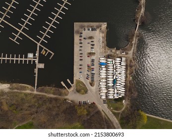 An Aerial View Above A Large Boat Harbor, Seen During The Offseason With Any Empty Water Harbor And Boats Seen On Land Storage.