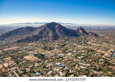 Aerial view above Paradise Valley, Arizona looking SW at Camelback Mountain on a cool December morning 2022