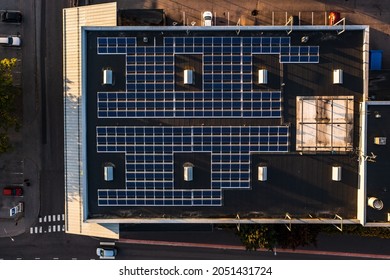 Aerial View Above Photovoltaic Cells On A Warehouse Roof - Top Down, Drone Shot