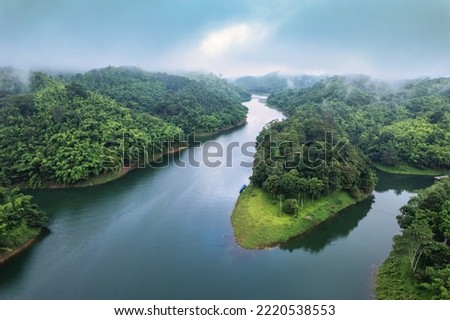 Aerial view of Abundance tropical rainforest with foggy and river flowing through in the morning at national park