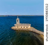 An aerial view across Rutland Water and the old church on the shore of at Normanton, UK on a bright sunny day