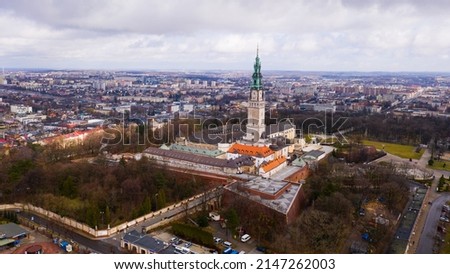 Aerial view of active Catholic Jasna Gora Monastery in Czestochowa on background with modern cityscape in spring, Poland