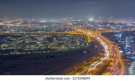 Aerial View Of Al Khail Road Busy Traffic Near Business Bay District Night Timelapse. Many Illuminated Apartment Houses In Dubai City From Above.