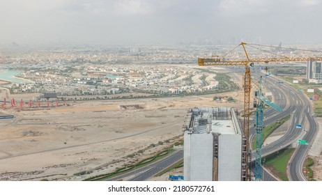 Aerial View Of Al Khail Road Busy Traffic On Junction Near Business Bay District Timelapse. Many Apartment Houses In Dubai City From Above. Luxury Villas With Construction Site