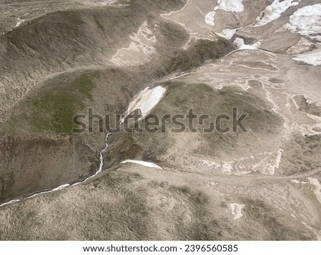 Aerial view of Alaskan tundra. In physical geography, tundra is a type of biome where tree growth is hindered by frigid temperatures and short growing seasons. 