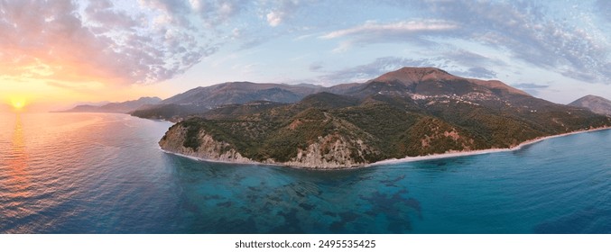 Aerial view of Albania's stunning coastline featuring a beautiful beach, turquoise waters, and majestic mountains. Ideal for highlighting Mediterranean landscapes, natural beauty, and travel  - Powered by Shutterstock