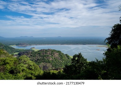 Aerial view of Aliyar dam in Tamil Nadu. Wide shot of the dam is located in the foothills of Valparai, in the Anaimalai Hills of the Western Ghats. Mountains border waterway. 