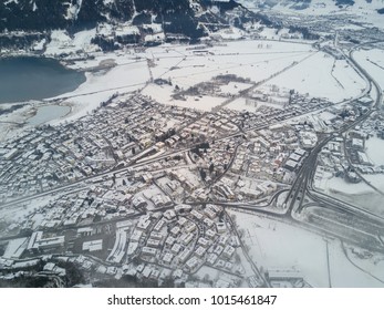 Aerial view of the Alps. The resort village of Zell am See near the lake. Peaks of mountains in the snow in winter. Ski resort in Austria. Leisure. Winter sports