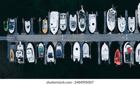 Aerial view of amazing boats.  Minimalistic landscape background with boats and sea in marina bay. Top view from drone of harbor with yacht - Powered by Shutterstock
