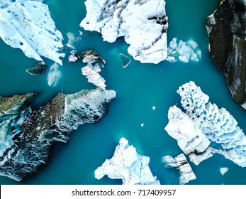 Aerial view of amazing glacier patterns and shapes in Jokulsarlon lake, Iceland. Glacial lagoon with icebergs floating. Climate change, global warming, melting glacier.