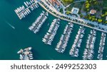 An aerial view of the amazing marina in Vrsar, Croatia, captured by a drone. This vibrant marina is filled with sleek yachts and boats, set against the backdrop of the picturesque Adriatic coastline