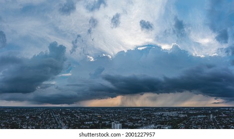 Aerial View Amazing Sunset Over Of The Suburbs With The City Under Dramatic Rain Cloud. Global Warming Effect Black Thunderstorm Dramatic Rain Clouds, Dramatic Sky.