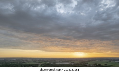 Aerial View Amazing Sunset Over Of The Suburbs With The City Under Dramatic Rain Cloud. Global Warming Effect Black Thunderstorm Dramatic Rain Clouds, Dramatic Sky, Shot By A Drone. High Quality Photo